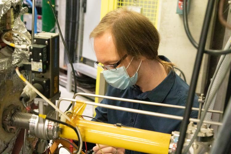Steve checking connections on the positron accumulator